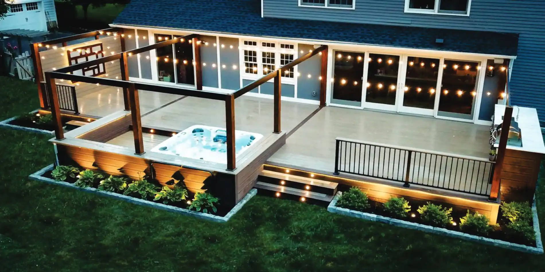Custom deck with pergola and string lights at night
